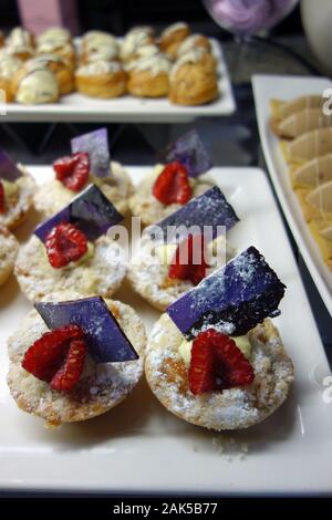 Small Fruit & Chocolate Topped Sponge Cakes in the Breakfast Buffet at the Azul Beach Resort Hotel, Puerto Morelos, Riviera Maya, Cancun. Mexico. Stock Photo