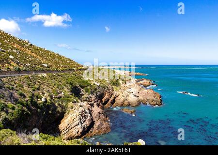 Empty coastal road to Cape Town with view over the turquoise Atlantic ocean and the rocky coastline, sunny day, South Africa Stock Photo
