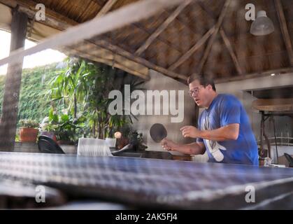 a young men playing table tennis Stock Photo