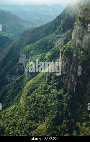 Huge Fortaleza Canyon with steep rocky cliffs covered by thick forest near Cambara do Sul. A town with natural tourist sights in southern Brazil. Stock Photo