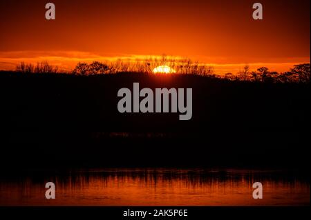 Sunset over the wetlands and woodlands, Lunt Meadows RSPB Nature Reserve, Merseyside Stock Photo