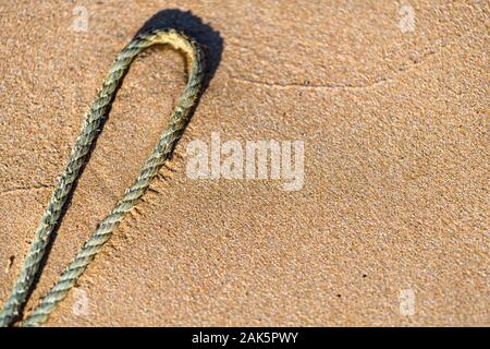 Rope on a golden sandy beach Stock Photo