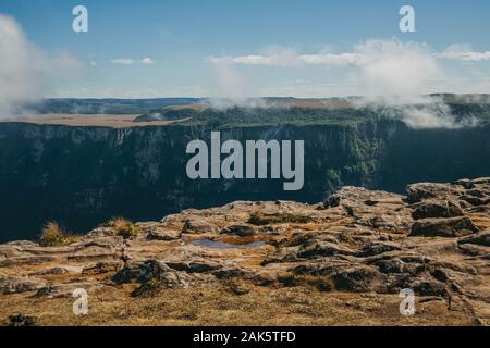 Fortaleza Canyon with steep rocky cliffs and mist coming up near Cambara do Sul. A town with natural tourist sights in southern Brazil. Stock Photo