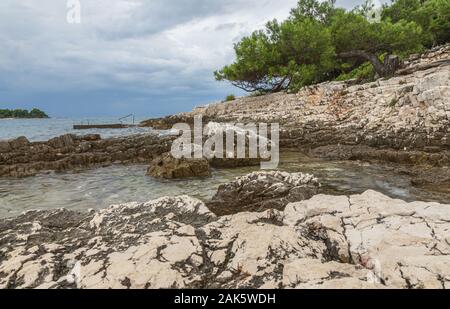 View on Adriatic sea at stormy day with big rocks. Region Istria, near the Rovinj city. Republic of Croatia