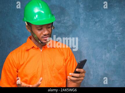 a young African engineer got excited by what he saw on his smart phone Stock Photo