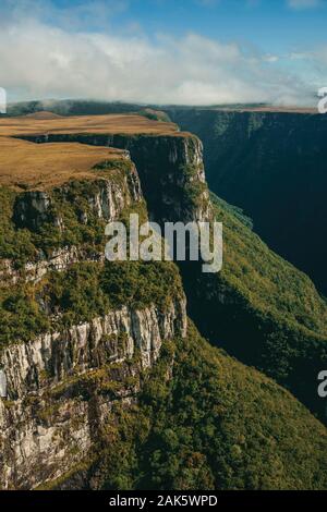 Fortaleza Canyon shaped by steep rocky cliffs with forest and flat plateau near Cambara do Sul. A town with natural tourist sights in southern Brazil. Stock Photo