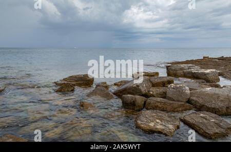 View on Adriatic sea at stormy day with big rocks. Region Istria, near the Rovinj city. Republic of Croatia