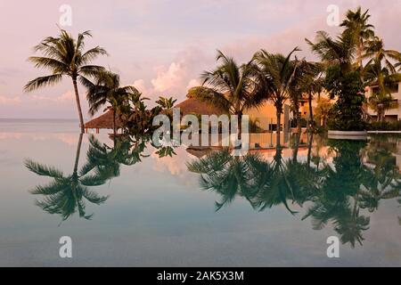 Mexico,Nayarit,Nuevo Vallarta, palm trees and buildings reflected in a swimming pool at Marival Armony Resort Stock Photo