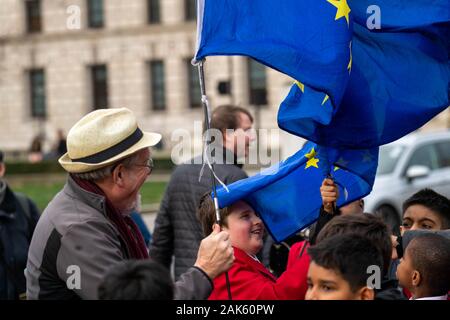London UK 7th Jan. 2020 Pro and anti brexit protesters outside the Houses of Parliament An anti brexit supporter allows some school children to wave his flags Credit Ian DavidsonAlamy Live News Stock Photo