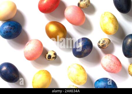 Decorative multi-colored Easter eggs in a nest on a white background. Stock Photo