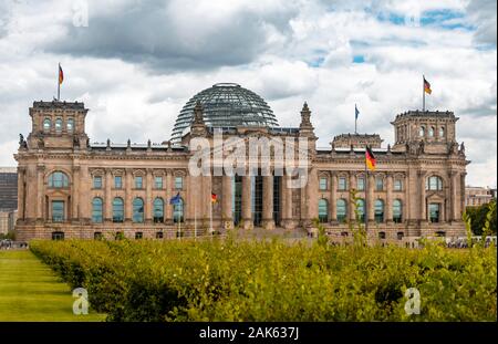 German flag flying next to the Reichstag or German parliament building, Regierungsviertel or government quarter, Berlin, Germany, Europe Stock Photo