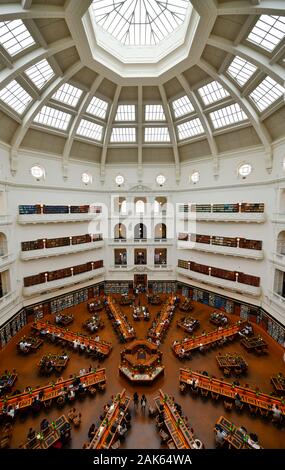 The Domed Reading Room in the State Library of Victoria, Melbourne Australia, with students studding and reading with arches books on shelves Stock Photo
