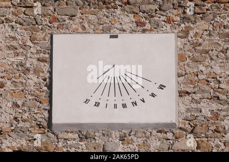 Old marble sundial on a brick wall Stock Photo