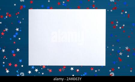 Blank paper card on blue background with confetti stars in American flag colors. Flat lay, top view, copy space. Happy Presidents Day, USA Independenc Stock Photo