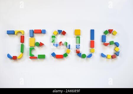 colorful wooden toy blocks lettering the name JESUS Stock Photo