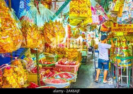 BANGKOK, THAILAND - APRIL 15, 2019: Walk in religious market with numerous colorful items for Buddhist and Chinese folk religion worships , on April 1 Stock Photo