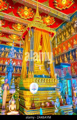 BANGKOK, THAILAND - APRIL 15, 2019: The large golden thron with Lord Buddha, sitting behing the golden curtains in   Phuttaisawan Royal Hall, on April Stock Photo