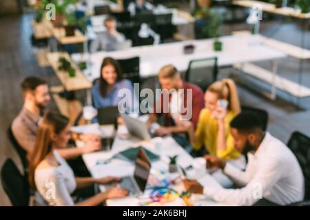 Team of creative designers working with laptops in office, blurred image Stock Photo