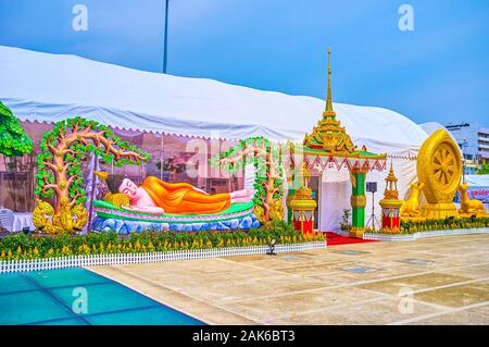 BANGKOK, THAILAND - APRIL 15, 2019: The beautiful colorful sculptures of the reclining Lord Buddha, located at the pavilions of religion goods fair on