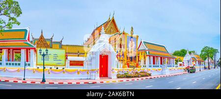 BANGKOK, THAILAND - APRIL 15, 2019: The amazing main gates of Wat Suthat temple and surrounding buildings of various purposes, on April 15 in Bangkok Stock Photo