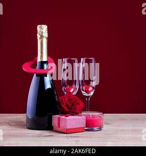 Greeting card for Womens or Mothers day. Valentines day concept with champagne glasses candle and hearts. Stock Photo