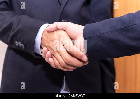 Close up business people shaking hands finishing up a meeting. businessman handshake for successful. Stock Photo