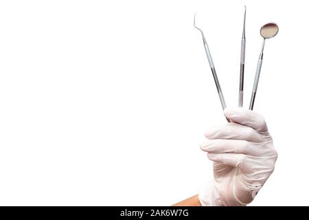 The dentist is holding the dentist tools isolated on white background. Stock Photo