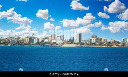 View of the Senegal capital of Dakar, Africa. It is a city panorama taken from a boat. There are large modern buildings and a blue sky with clouds. Stock Photo