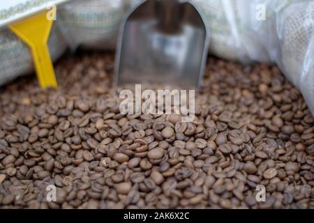 Coffee beans close-up in sack. It was photographed in front of the coffee shop. Stock Photo