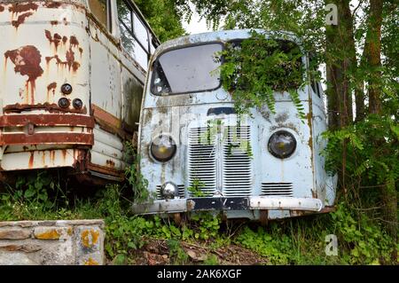 A old destroyed and obsolete truck abandonned in middle of countryside, in the nature Stock Photo