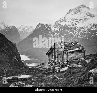 photograph of a c 1888 black & white Magic Lantern glass slide on a light box of a wooden hut above Nordfjord Oldendal Brynestad Saeter Norway.  Original photographers copyright expired. Digital photograph copyright Doug Blane. Digital restoration & editing copyright Doug Blane. Stock Photo