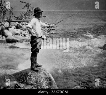 photograph of a c 1910 black & white Magic Lantern glass slide on a light box of an Victorian / Edwardian man fly fishing on a river in Scotland, hat, pipe, rod, gaiters, boots. Original photographers copyright expired. Digital photograph copyright Doug Blane. Digital restoration & editing copyright Doug Blane. Stock Photo