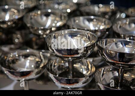 lots of little silver cups stacked on top of each other Stock Photo