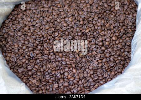 Coffee beans close-up in sack. It was photographed in front of the coffee shop. Stock Photo