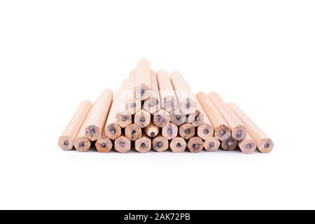 One makes a difference. Pencils stacked on top of each other in the form of a pyramid with one turned with the tip towards the camera, isolated. Stock Photo