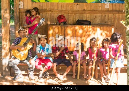 Puerto Iguazu, Argentina - Circa November 2019: Guarani indigenous group playing typical music for donations at the Iguazu National Park Stock Photo