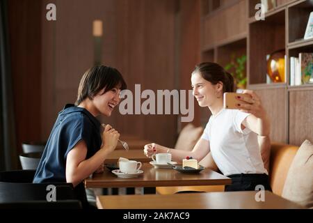 Young girlfriends at a cafe Stock Photo