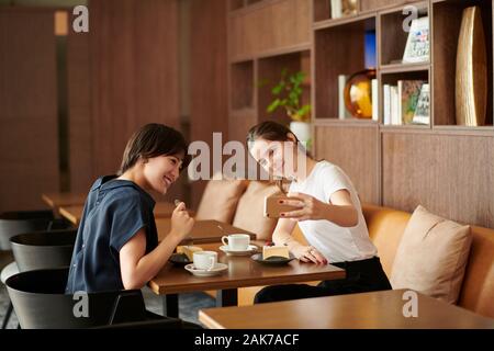 Young girlfriends at a cafe Stock Photo