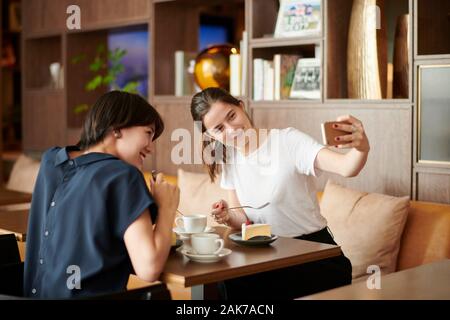 Young girlfriends at a cafe Stock Photo
