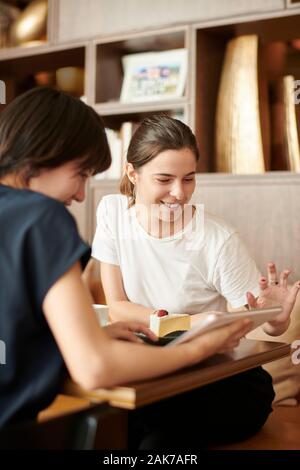 Young girlfriends at a cafe Stock Photo