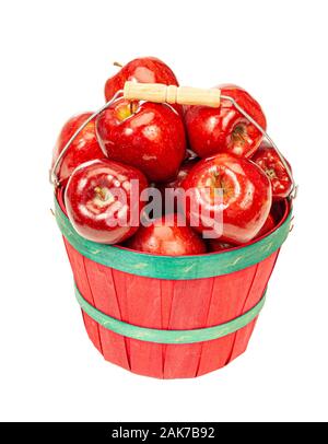 Vertical shot of a red bushel basket with green bands full of red shiny apples isolated on white. Stock Photo