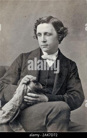 LEWIS CARROLL (1832-1898) Chrales Dodgson. English writer andf photographer seen here about 1855 holding a camera lens