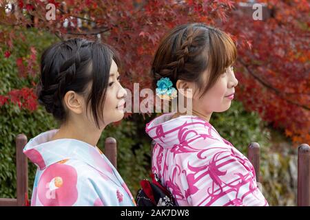 two women in traditional costume near Tenryū-ji temple, Kyoto, Japan Stock Photo