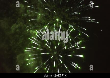 Fireworks, green on a dark sky background. Stock Photo
