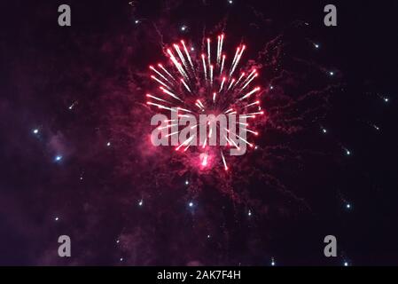 Bright red fireworks against the dark sky. Stock Photo