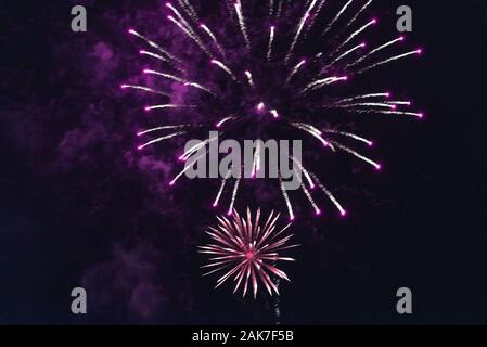 Bright red fireworks against the dark sky. Stock Photo