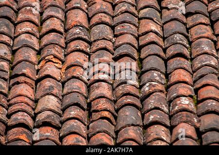 Old vintage red ceramic roof tiles closeup as background Stock Photo