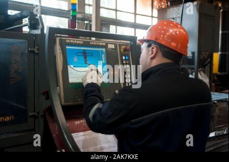 Industrial worker operating control panel system Stock Photo
