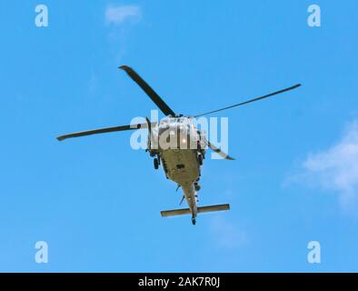 Sikorsky MH-60 Pave Hawk helicopter flying overhead in the sky Stock Photo