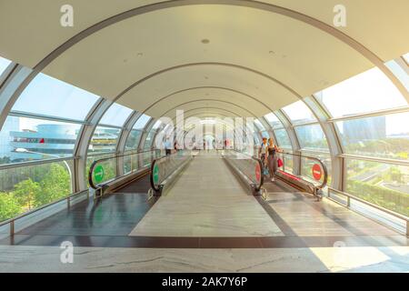 Singapore - Aug 8, 2019: front view of large moving sidewalk inside Jewel Changi International Airport terminal 3 opened in April 2019. People Stock Photo